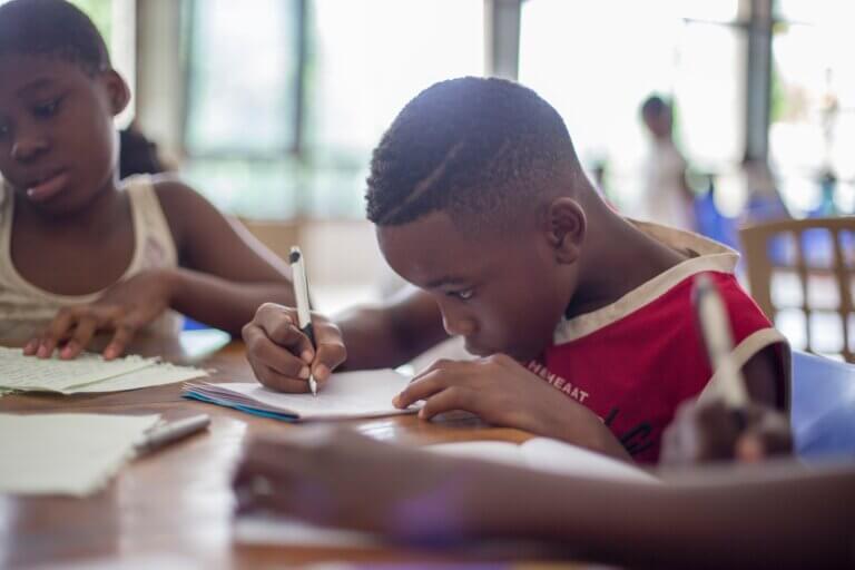 A black boy studying at school